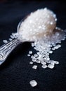 Beautiful sugar cubes on a silver spoon with black background. Macro image. Subject is in focus background blur Royalty Free Stock Photo