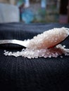 Beautiful sugar cubes on a silver spoon with black background. Macro image. Subject is in focus background blur Royalty Free Stock Photo