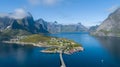 Beautiful summer aerial view of Reine, Norway, Lofoten Islands, with skyline, mountains, famous fishing village with red fishing c Royalty Free Stock Photo