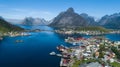 Beautiful summer aerial view of Reine, Norway, Lofoten Islands, with skyline, mountains, famous fishing village with red fishing c