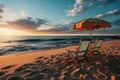 Beautiful summer beach. Two chairs, sun loungers and beach umbrella on the sandy beach against the backdrop of the sea in sunset. Royalty Free Stock Photo