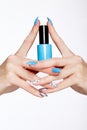 Beautiful summer blue manicure on female hand with nail polish . Close-up.