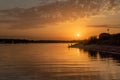 Evening bright dramatic sunset over the river. Evening fishing. Royalty Free Stock Photo