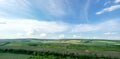 Beautiful summer countryside landscape against the background of blue sky and white clouds Royalty Free Stock Photo