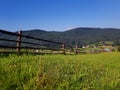 Beautiful summer countryside landscape with forested hills, grassy rural field in mountains. Sunny day, clear blue sky. Carpathian Royalty Free Stock Photo