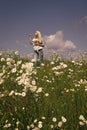 Beautiful summer day. Girl with flowers on camomile meadow Royalty Free Stock Photo