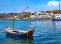 Beautiful summer day in typical Greek island. Fishing boats, whitewashed house. Small blue boat in foreground. Mykonos Royalty Free Stock Photo