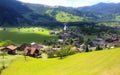 Beautiful summer day view from train window in miniature style of Lungern Village surrounding its Pfarrkirche Catholic Church Royalty Free Stock Photo