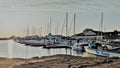 On a beautiful summer evening, the sun sets over the docked boats at the wharf of Summerside, PEI.
