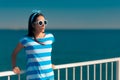 Beautiful summer fashion girl in navy striped shirt and sunglasses Royalty Free Stock Photo