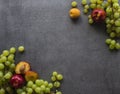 Beautiful summer fruits border on dark background