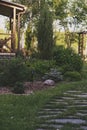 Beautiful summer garden view with curvy stone pathway and wooden archway (pergola). Royalty Free Stock Photo