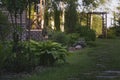 Beautiful summer garden view with curvy stone pathway and wooden archway (pergola). Royalty Free Stock Photo