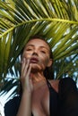 Beautiful summer girl in sunset. young sexy woman in bikini under palm tree Royalty Free Stock Photo