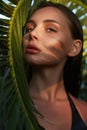 Beautiful summer girl in sunset. young sexy woman in bikini under palm tree Royalty Free Stock Photo