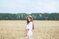 Beautiful summer girl a wheat field, a white dress, A sunny day. Teenage model summer holidays, vacation and people concept. Rich