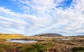 Beautiful summer icelandic landscape panoramic view with grassland, colorful mountain ranges, and beautiful sky as a background.