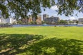 A beautiful summer landscape with a boat sailing along the flowing waters of Cape Fear River, lush green trees and grass