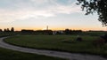 Beautiful summer landscape countryside at sunset. Path to the village. Great holiday home in the countryside. Evening.