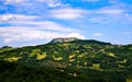 Beautiful summer landscape with green meadow, mountains and blue sky, Bismantova Rock Royalty Free Stock Photo