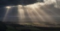 Stunning Summer landscape image of escarpment with dramatic storm clouds and sun beams streaming down Royalty Free Stock Photo