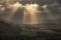 Stunning Summer landscape image of escarpment with dramatic storm clouds and sun beams streaming down Royalty Free Stock Photo