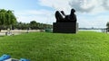 a beautiful summer landscape at Maurice A. Ferre Park with black plastic sculptures surrounded by ocean water and lush green palm