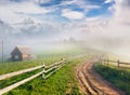 Beautiful summer landscape in a mountain village. Foggy morning Royalty Free Stock Photo