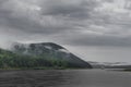 Beautiful summer landscape. river on a background of high mountains. white clouds on blue sky Royalty Free Stock Photo