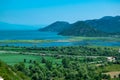 Beautiful summer landscape of Skadar Lake with green and blue water, mountains hills. Clear sky. Montenegro Royalty Free Stock Photo