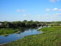 Beautiful summer landscape with a view of an old vintage bridge over a small river Royalty Free Stock Photo