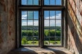 Beautiful summer landscape view with trees and sky seen through an ancient old castle window. Royalty Free Stock Photo