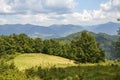 Beautiful summer mountain slope with blue sky and white clouds. Carpathian Mountains, Ukraine Royalty Free Stock Photo