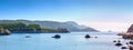 Beautiful summer panoramic seascape. View of the cliff into the sea bay with crystal clear azure water in sunshine daylight. Boats