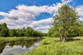 Beautiful summer river at sunny day with clouds reflection in the water Royalty Free Stock Photo