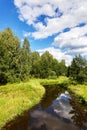 Beautiful summer river at sunny day with clouds reflection in the water Royalty Free Stock Photo