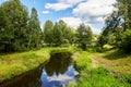 Beautiful summer river at sunny day with clouds reflection in the water Royalty Free Stock Photo