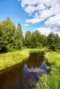 Beautiful summer river at sunny day with clouds reflection in the water Royalty Free Stock Photo