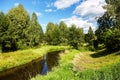 Beautiful summer river at sunny day with clouds reflection in the water Royalty Free Stock Photo