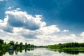 Beautiful summer rural landscape with river and clouds on the blue sky. Russia. Ural. Village Sloboda Royalty Free Stock Photo