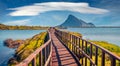 Beautiful summer scenery. Amazing summer view of Spiaggia di Porto Taverna beach with wooden footpath bridge. Royalty Free Stock Photo