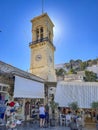 Beautiful summer scenery under the dominating clock tower in front of the church of Dormition at Hydra island Greece Royalty Free Stock Photo