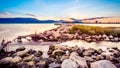 Beautiful summer sunset over the rocky shore by the sea Royalty Free Stock Photo