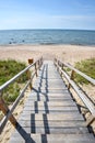 Beautiful summer view of the Baltic Sea, sandy beach, trail of wooden planks and bright blue sky Royalty Free Stock Photo