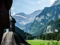 A beautiful summer view of the old church`s dome, the green valley and the Alps mountain range in Engelberg, Switze the green vall
