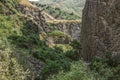 View of the mountain road through the gorge Garni covered with green shrubs and grass on the hills and basalt rocks standing verti Royalty Free Stock Photo