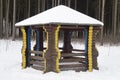 A beautiful summerhouse under a layer of snow in the city park