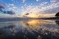 Beautiful summertime view seascape. The wet sand on the sea coast. Unbelievable sunrise. Morning landscape. High waves with foam. Royalty Free Stock Photo