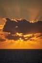 The beautiful sun behind clouds rises brilliantly over the Atlantic Ocean in the early morning, upright on the Canary Island of Royalty Free Stock Photo