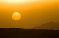 Beautiful sun disk low over mountain horizon Royalty Free Stock Photo